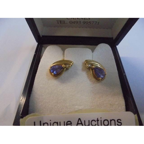 1035 - A pair of 9ct gold and amethyst earrings.