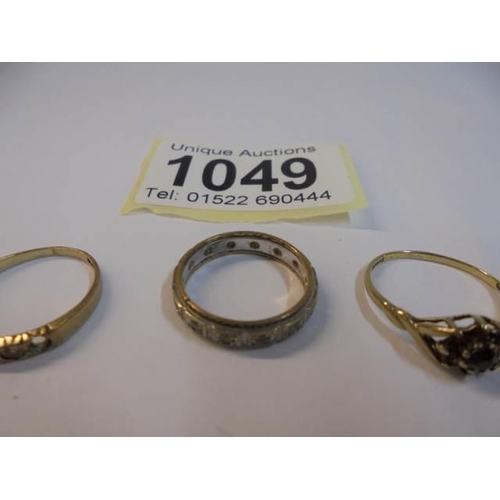 1049 - Two 9ct gold rings, sizes K & L and a 9ct gold eternity ring size J. 4.4 grams.