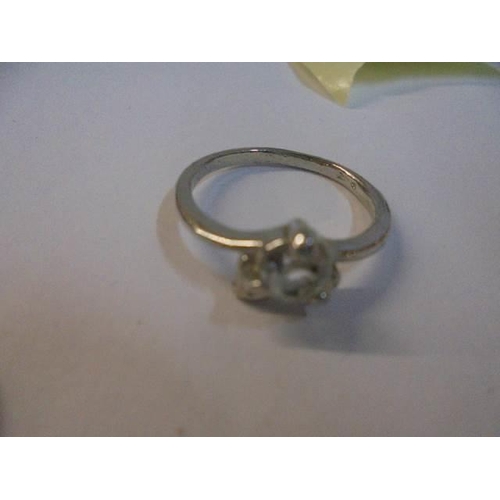 1050 - Two yellow metal rings, a white metal ring and a tiny yellow metal ring.