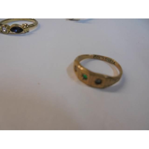 1050 - Two yellow metal rings, a white metal ring and a tiny yellow metal ring.