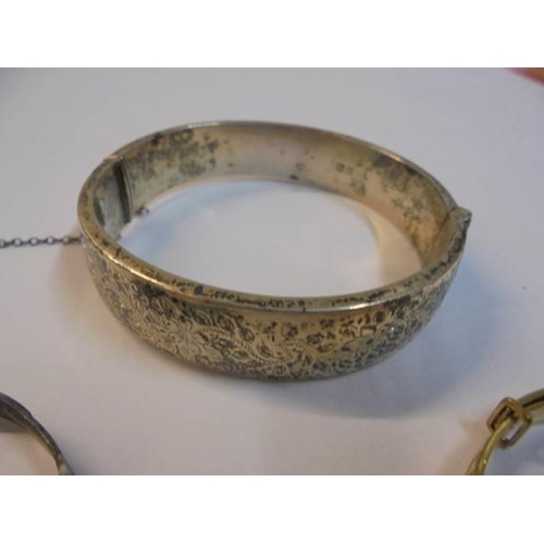 1065 - A silver bangle, a silver babies bangle and a gold plated babies bangle.