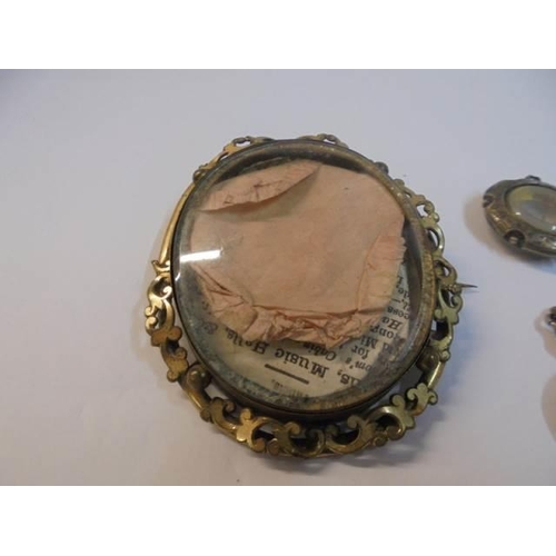 1070 - A large Victorian photo brooch a/f, four other Victorian items and a marcasite brooch.