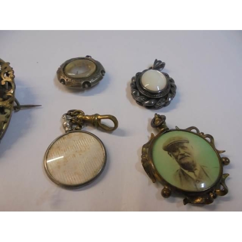 1070 - A large Victorian photo brooch a/f, four other Victorian items and a marcasite brooch.