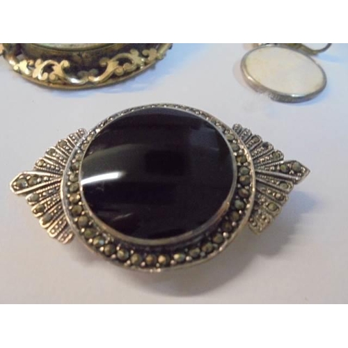 1070 - A large Victorian photo brooch a/f, four other Victorian items and a marcasite brooch.