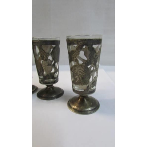 1074 - A set of silver encased licquor glasses.