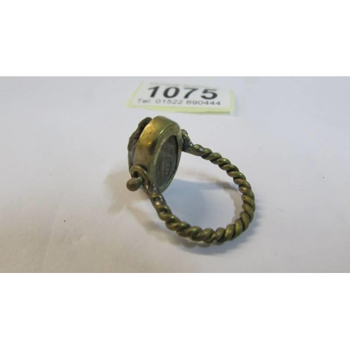 1075 - An old ring set with a carved stone scarab.