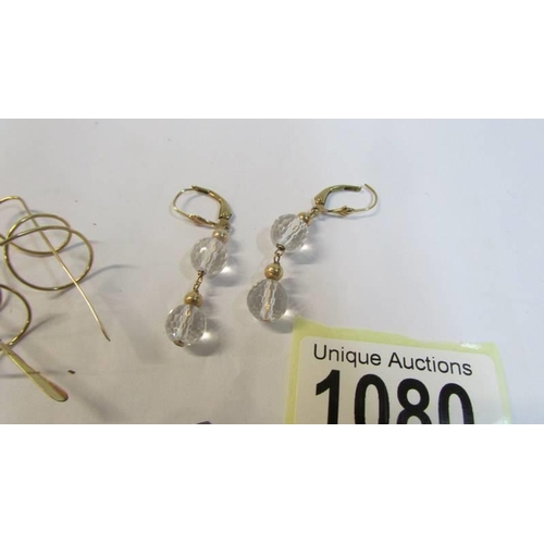 1080 - A pair of 9ct gold earrings, 1 gram, a pair of 9ct and clear stone earrings, 3 grams and a dark ston... 