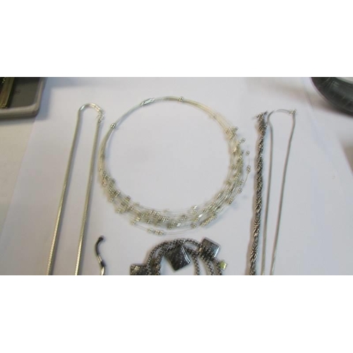 1092 - A quantity of white metal necklaces and bracelets, (possibly silver but not marked).