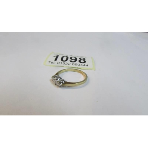 1098 - A vintage diamond three stone quarter carat ring in gold shank, size O, 1.77 grams.