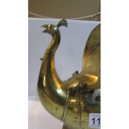 1125 - An Eastern brass hot water jug in the form of a peacock.