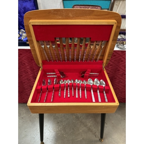 303 - A vintage cutlery table with cutlery & Large quantity of cutlery sets etc. COLLECT ONLY.