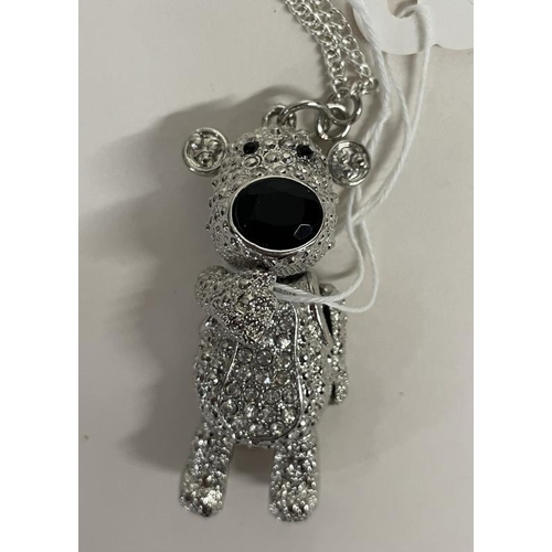 651 - A white metal articulated teddy bear on a long chain.