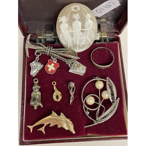 652 - A quantity of brooches & charms etc.