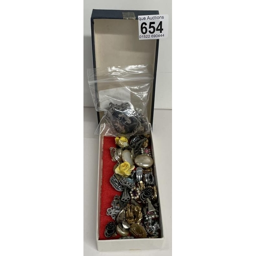 654 - A quantity of clip-on earrings and charms A/F