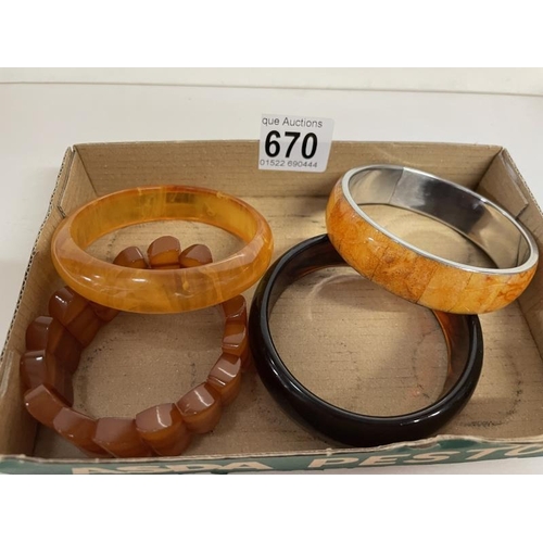 670 - Four amber coloured bangles