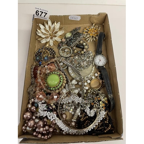 677 - A quantity of brooches, watches and necklaces etc