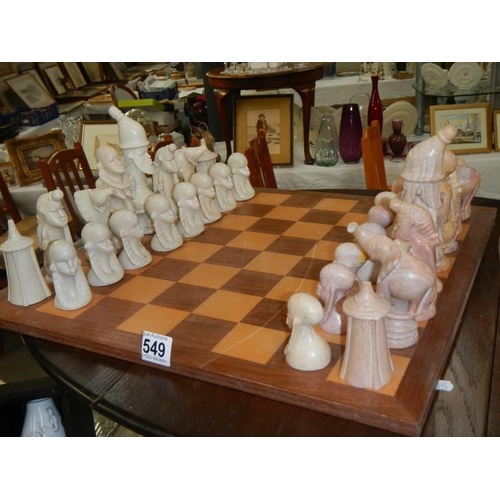 549 - A stone chess set, (one piece repaired).