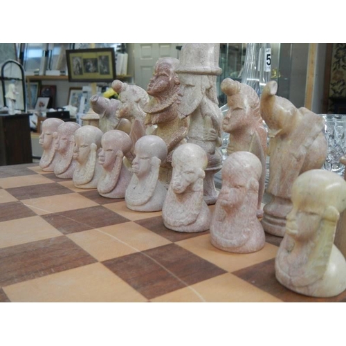 549 - A stone chess set, (one piece repaired).