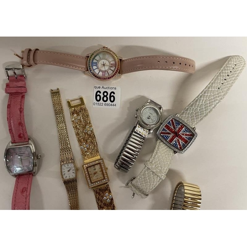 686 - Seven assorted wrist watches & 2 coins