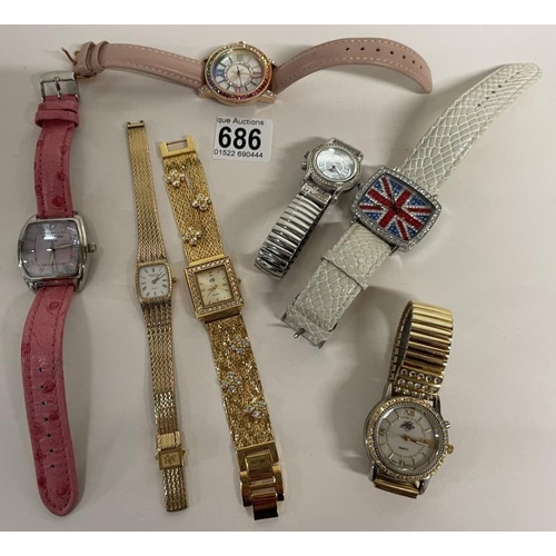 686 - Seven assorted wrist watches & 2 coins