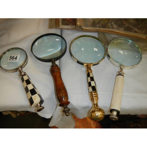 564 - Four assorted magnifying glasses.