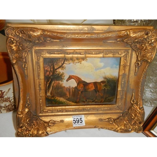 595 - A gilt framed study of a racehorse.