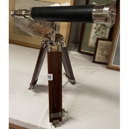 809 - A brass adjustable telescope on tripod.