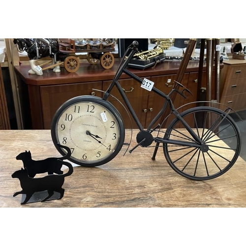 817 - A clock in a metal bike and metal cat