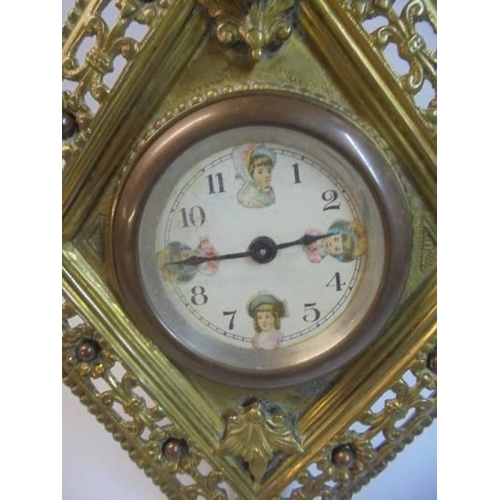 1131 - A brass diamond shaped cherub surmounted clock, circa 1900 by William Tonks, 21.5 cm tall.