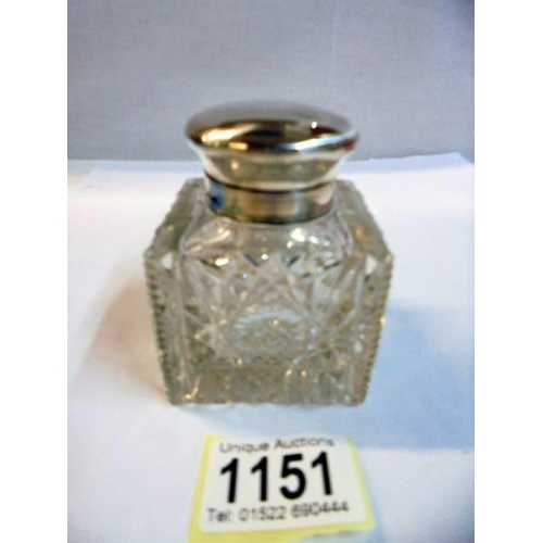 1151 - A cut glass inkwell with silver top.