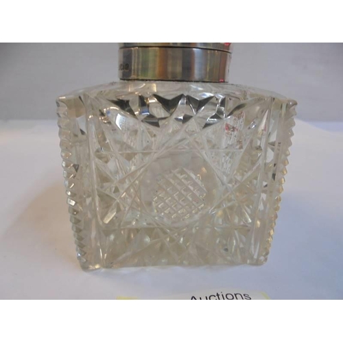 1151 - A cut glass inkwell with silver top.