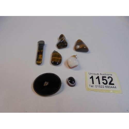 1152 - A quantity of polished stone pendants etc.,