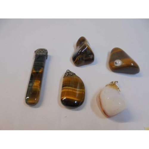 1152 - A quantity of polished stone pendants etc.,