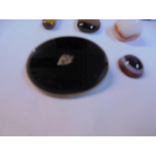 1152 - A quantity of polished stone pendants etc.,