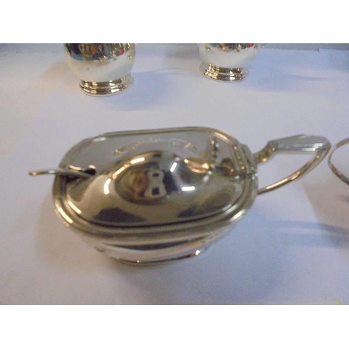 1153 - A pair of silver plate salts with spoons and blue glass liners and three others.