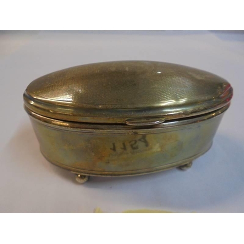 1154 - An oval silver dressing table trinket box.