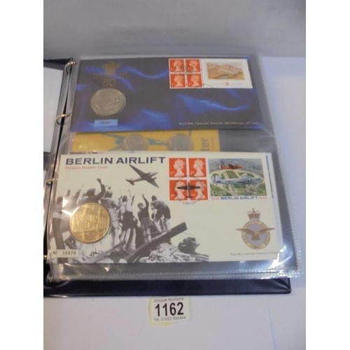 1162 - An album of coin covers and coin set including Manchester 2002.