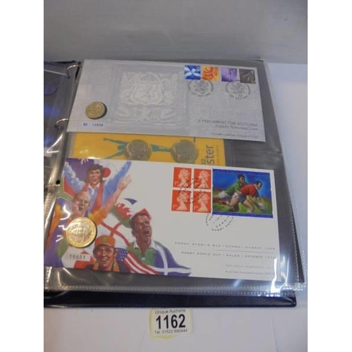 1162 - An album of coin covers and coin set including Manchester 2002.