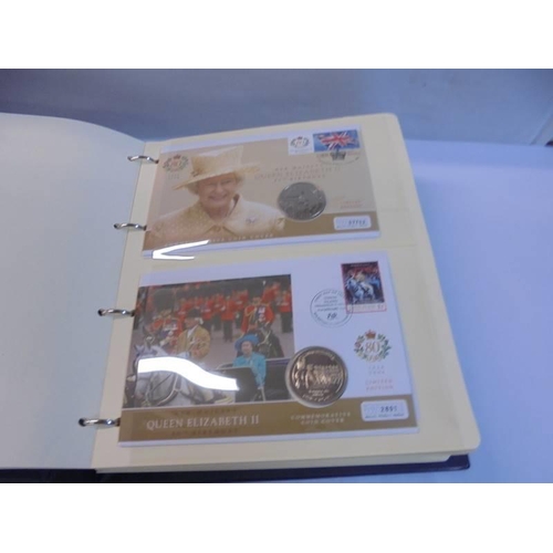 1163 - An album of Queen Elizabeth II 80th birthday coin covers and three other coin covers.