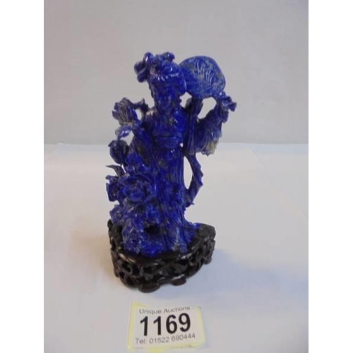 1169 - A Chinese carved blue stone figure,