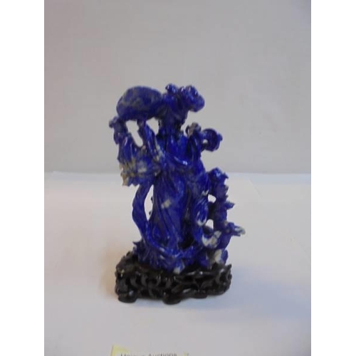 1169 - A Chinese carved blue stone figure,