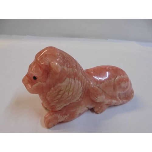 1172 - A small Chinese carved pink stone lion.