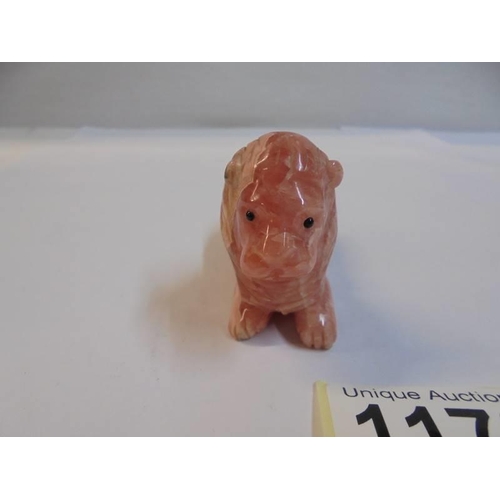 1172 - A small Chinese carved pink stone lion.