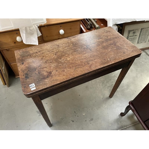 823 - A mahogany fold over card table, COLLECT ONLY.