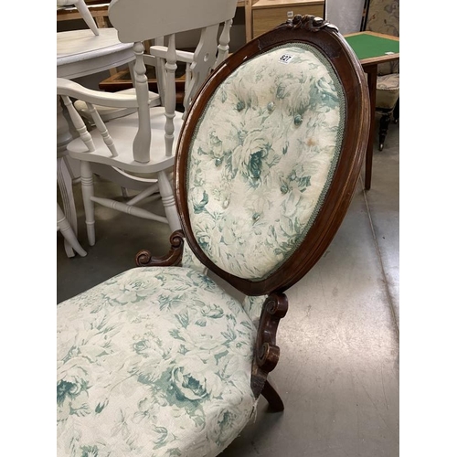 827 - An oval back nursing chair with rose print fabric A/F COLLECT ONLY