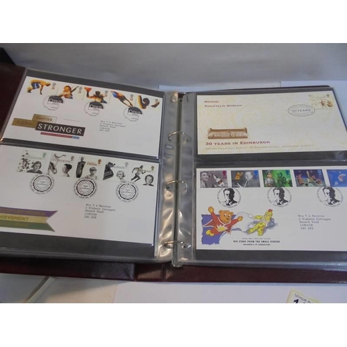 1180 - A Royal Mail first day covers album with 60 first day covers.