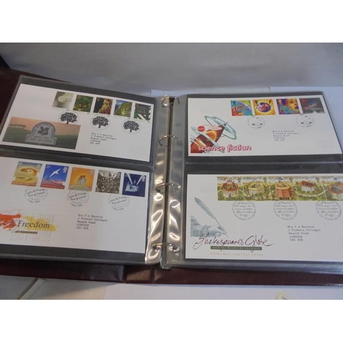 1180 - A Royal Mail first day covers album with 60 first day covers.