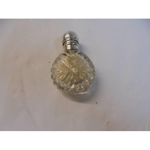 1200A - Two small silver topped scent bottles (one with original stopper).