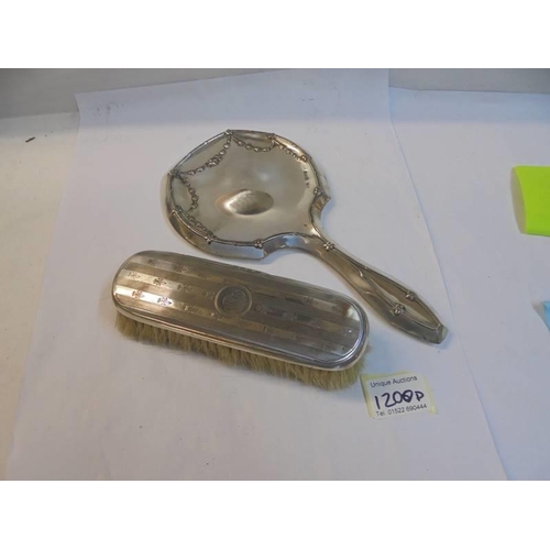 1200D - A good hall marked silver hand mirror and a silver backed hair brush.