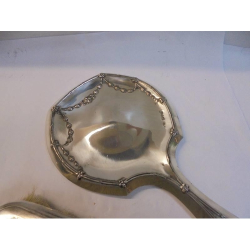 1200D - A good hall marked silver hand mirror and a silver backed hair brush.